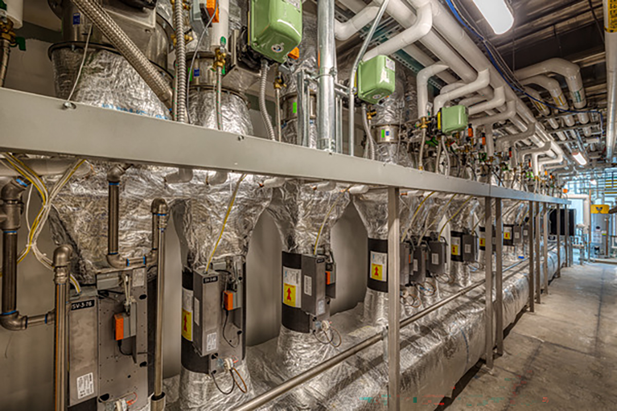 Industrial mechanical room with pipes, valves, and equipment