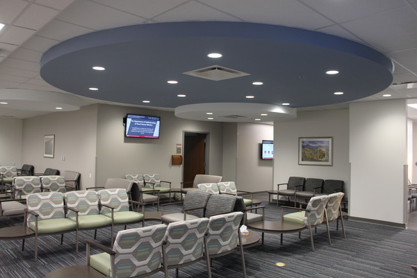 Open lobby space with seating and flat screen display