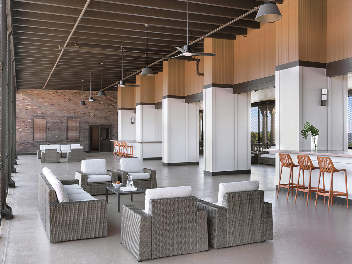 Modern lounge or common area with orange seating and wood ceiling
