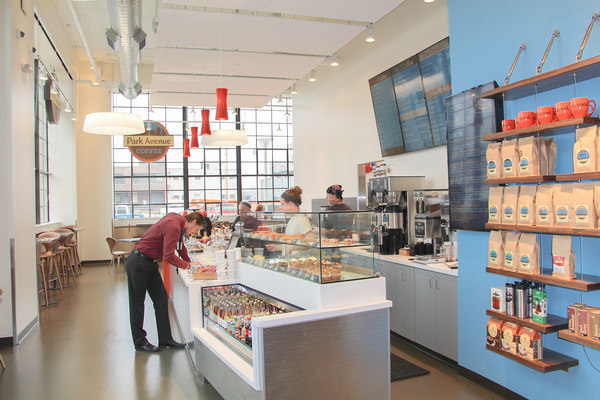Open coffee shop with staff at a service counter