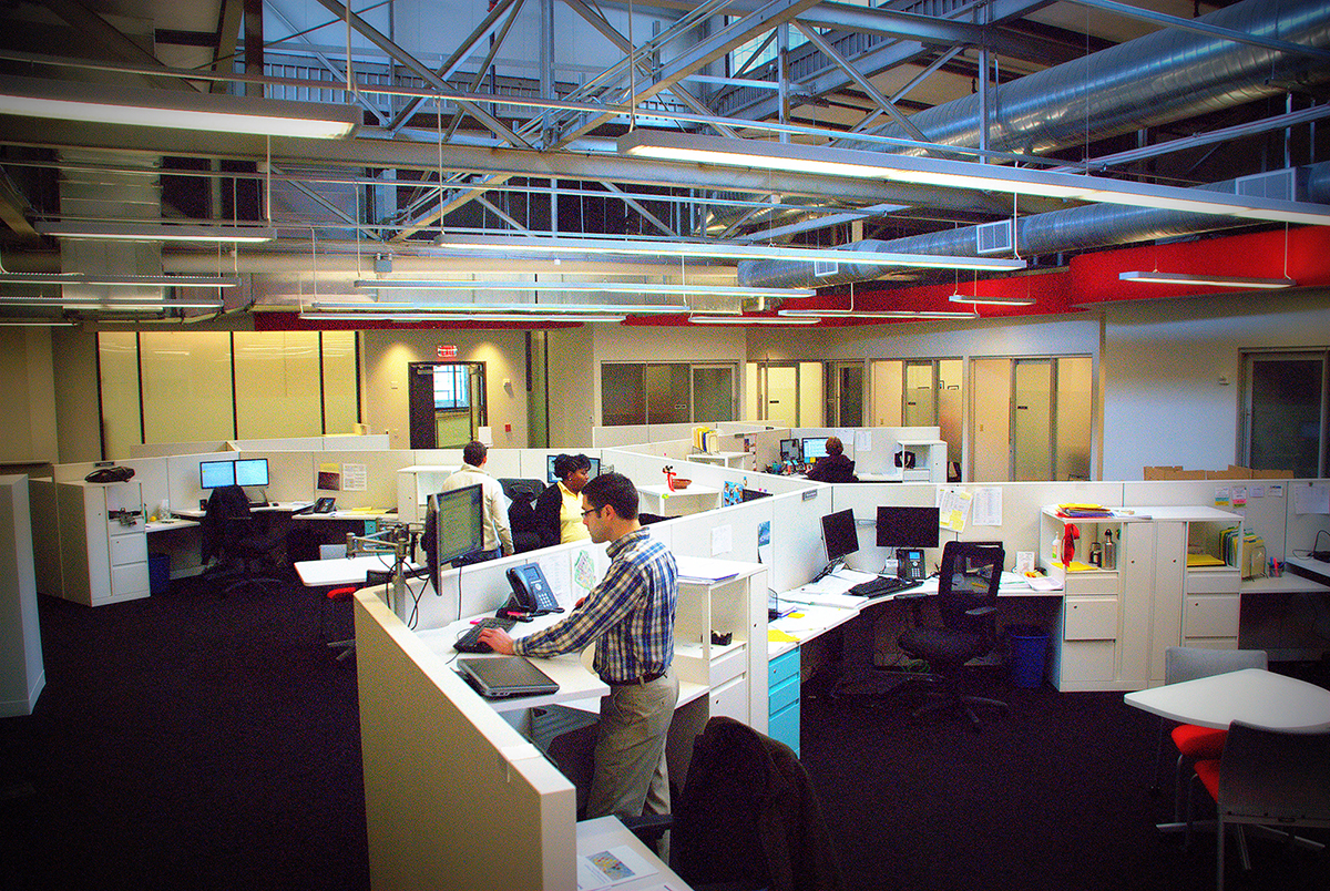 Modern office space with colorful equipment and workstations