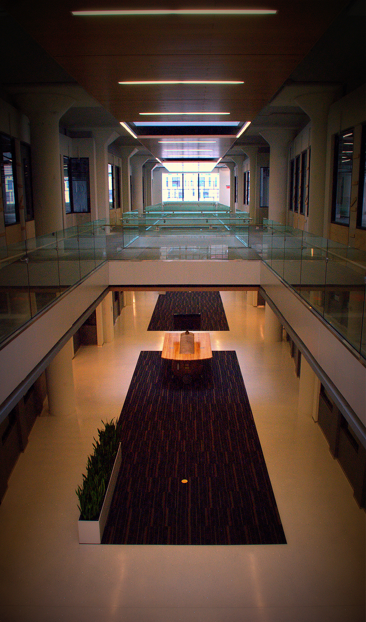 Long interior corridor space with dark finishes